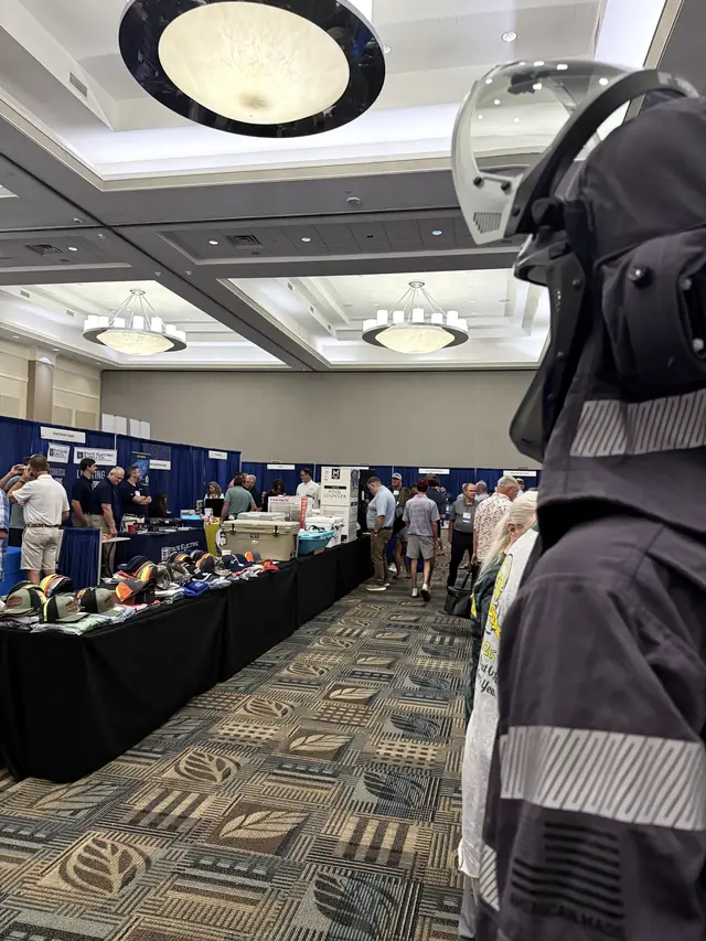 A protective arc-flash hood at an exhibitor booth
